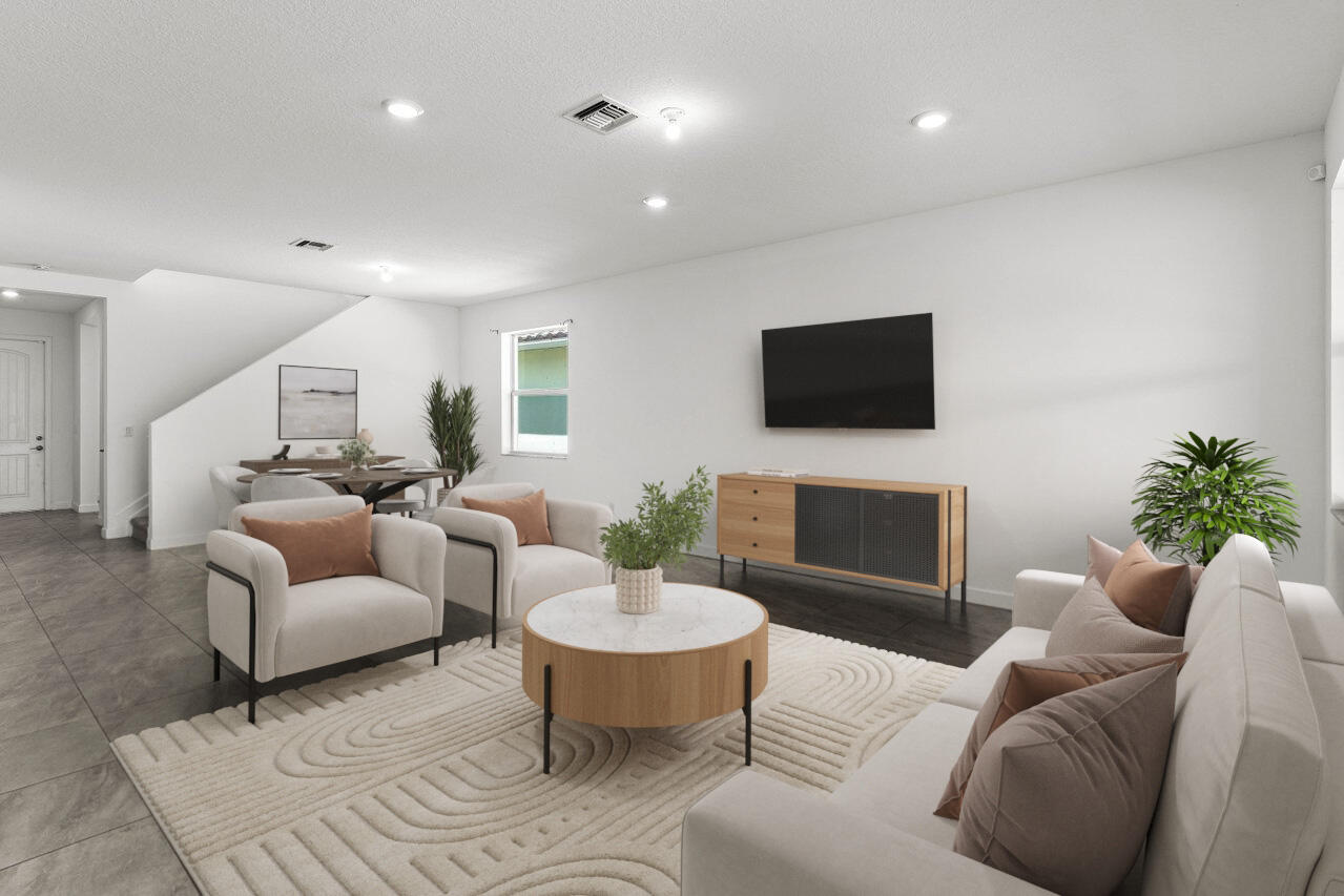 19659 Rugged Trunk Trail Loxahatchee, FL 33470 - Photo 10 of 61 a living room with furniture a flat screen tv and a lamp