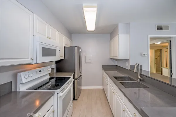a kitchen with a stove a sink and a refrigerator