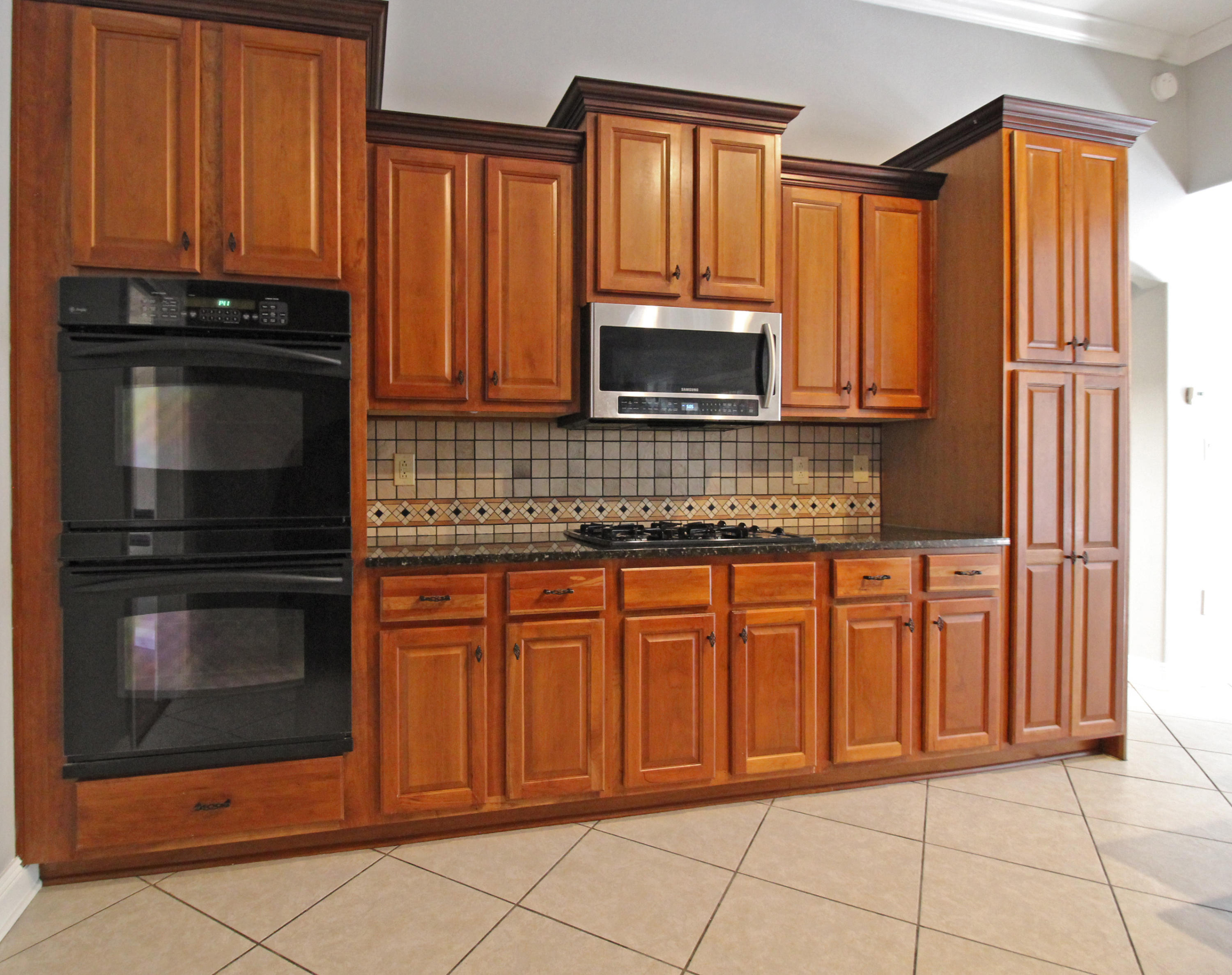 189 Red Maple Way Niceville, FL 32578 - Photo 14 of 58 a kitchen with granite countertop a stove microwave and cabinets