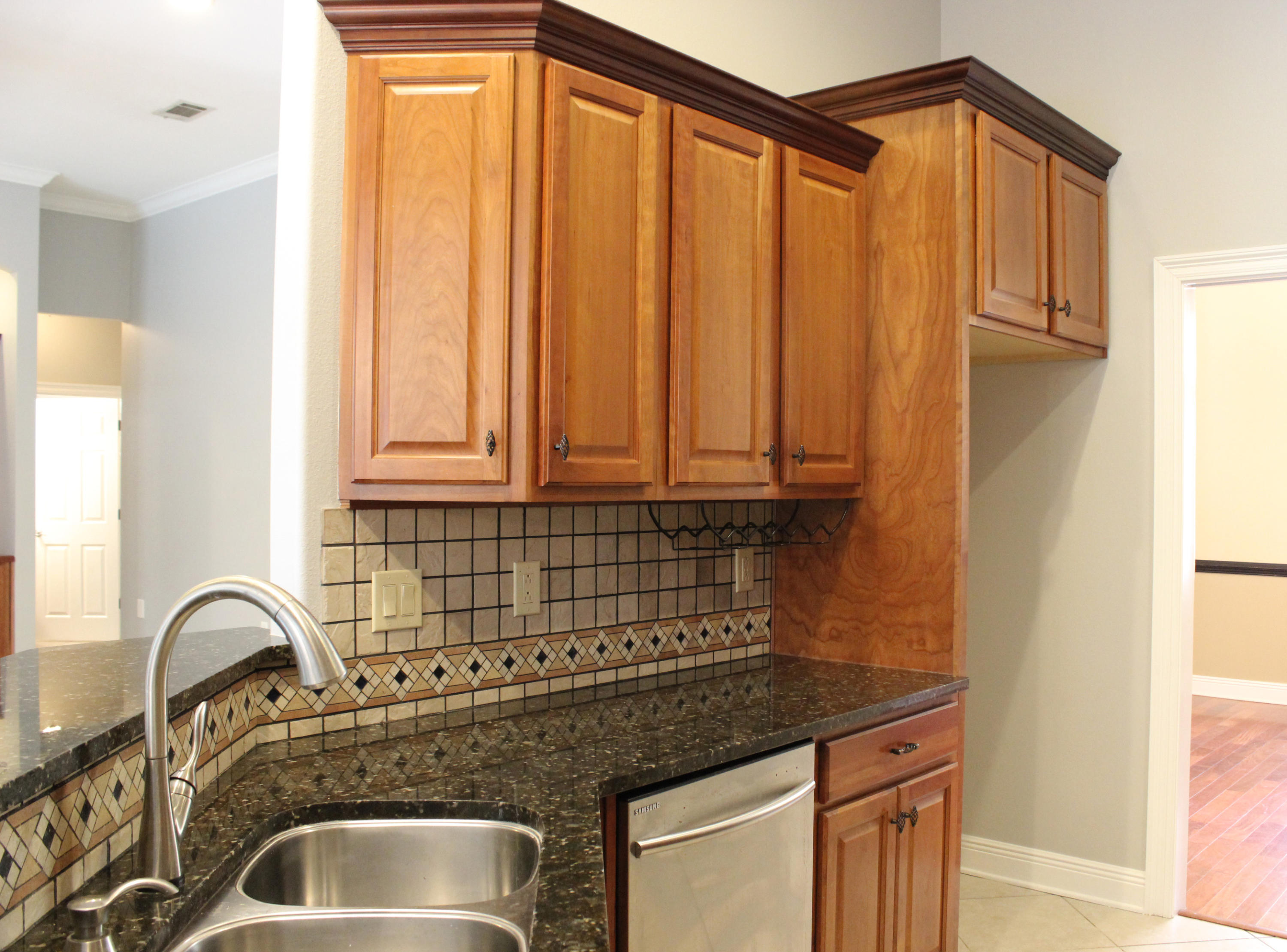 189 Red Maple Way Niceville, FL 32578 - Photo 16 of 58 a kitchen with granite countertop a sink and cabinets