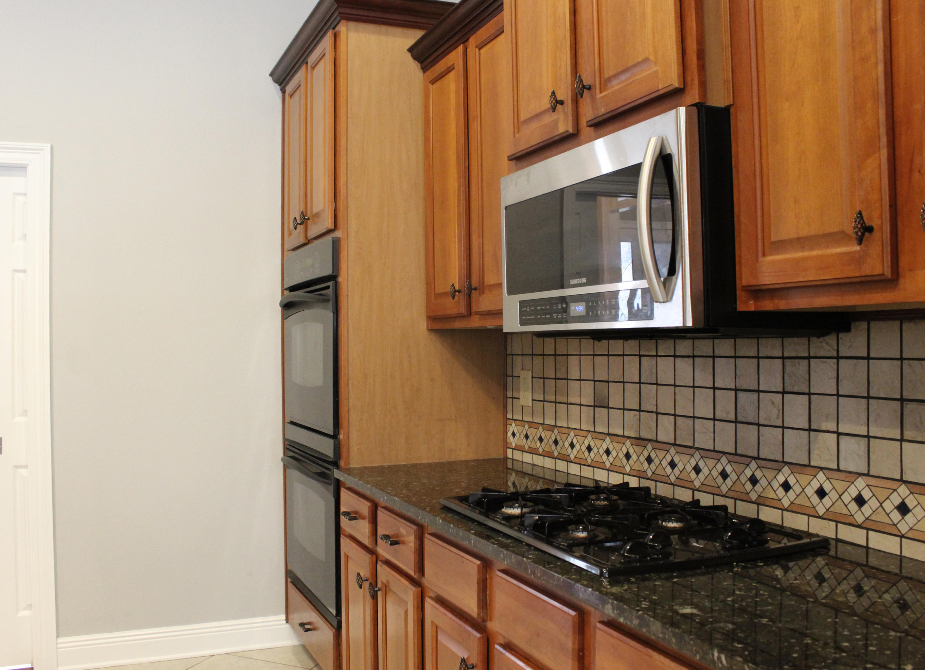 189 Red Maple Way Niceville, FL 32578 - Photo 17 of 58 a kitchen with a stove and a microwave