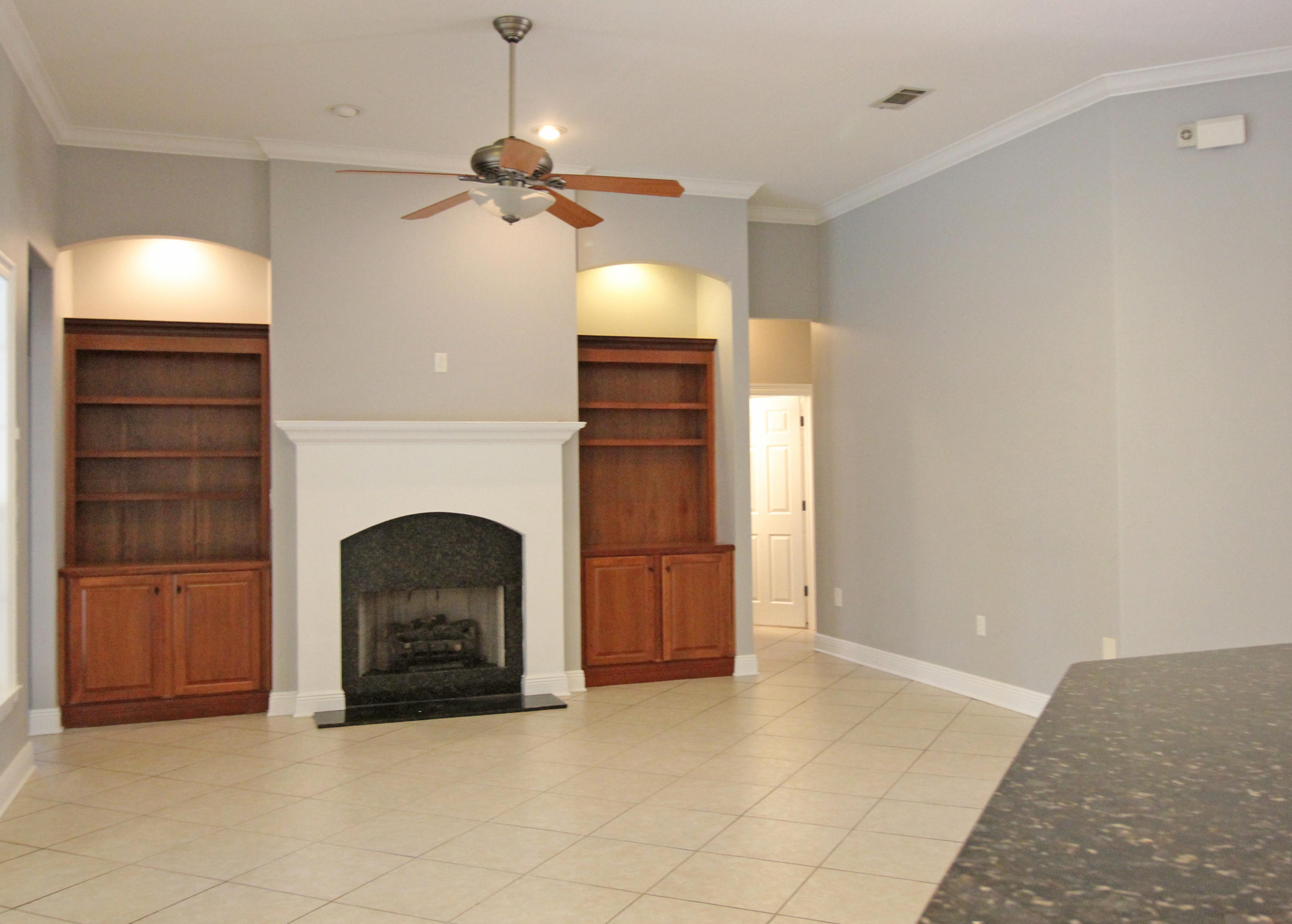 189 Red Maple Way Niceville, FL 32578 - Photo 24 of 58 a view of an empty room with a fireplace and cabinet