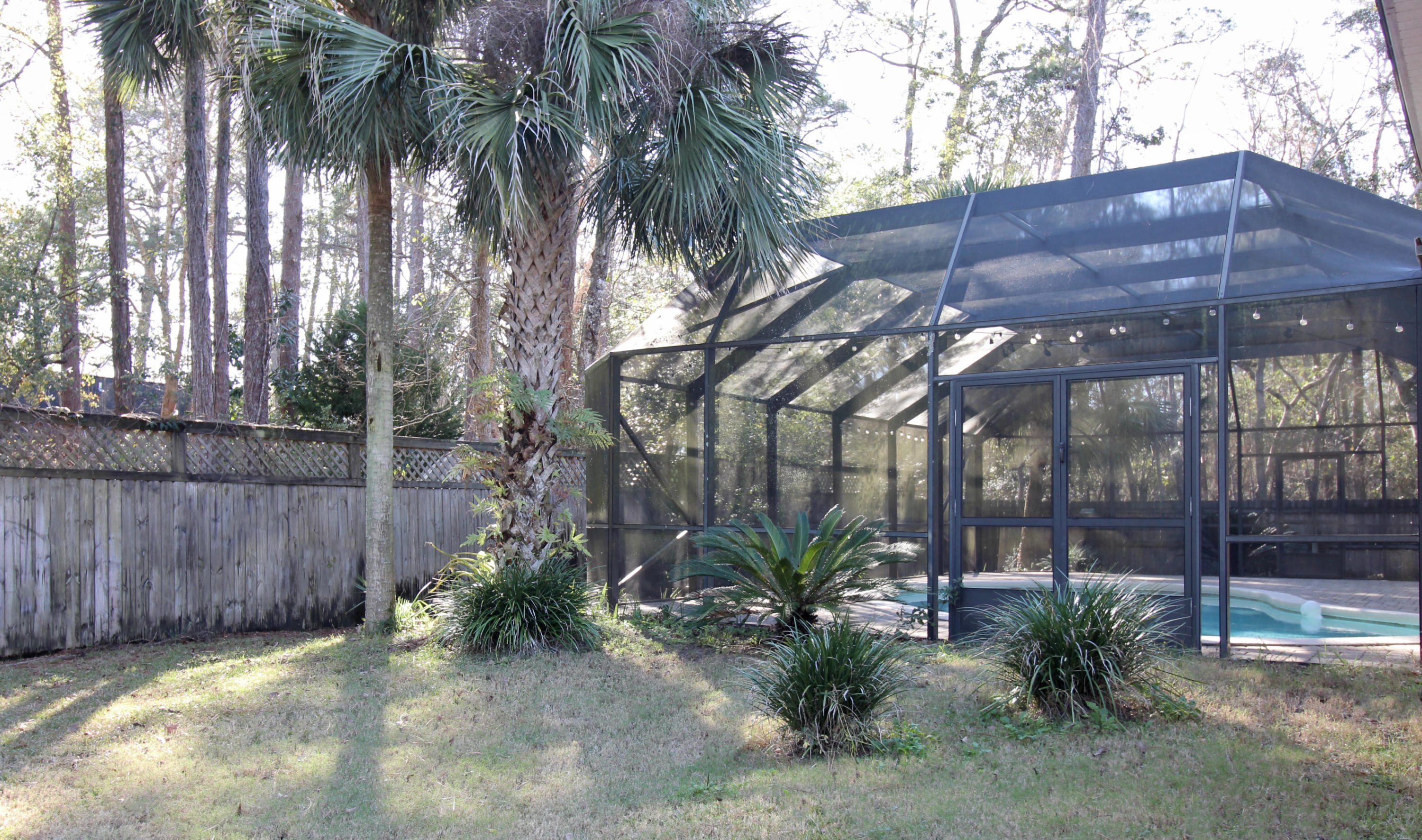 189 Red Maple Way Niceville, FL 32578 - Photo 51 of 58 a backyard of a house with a table and chairs under an umbrella