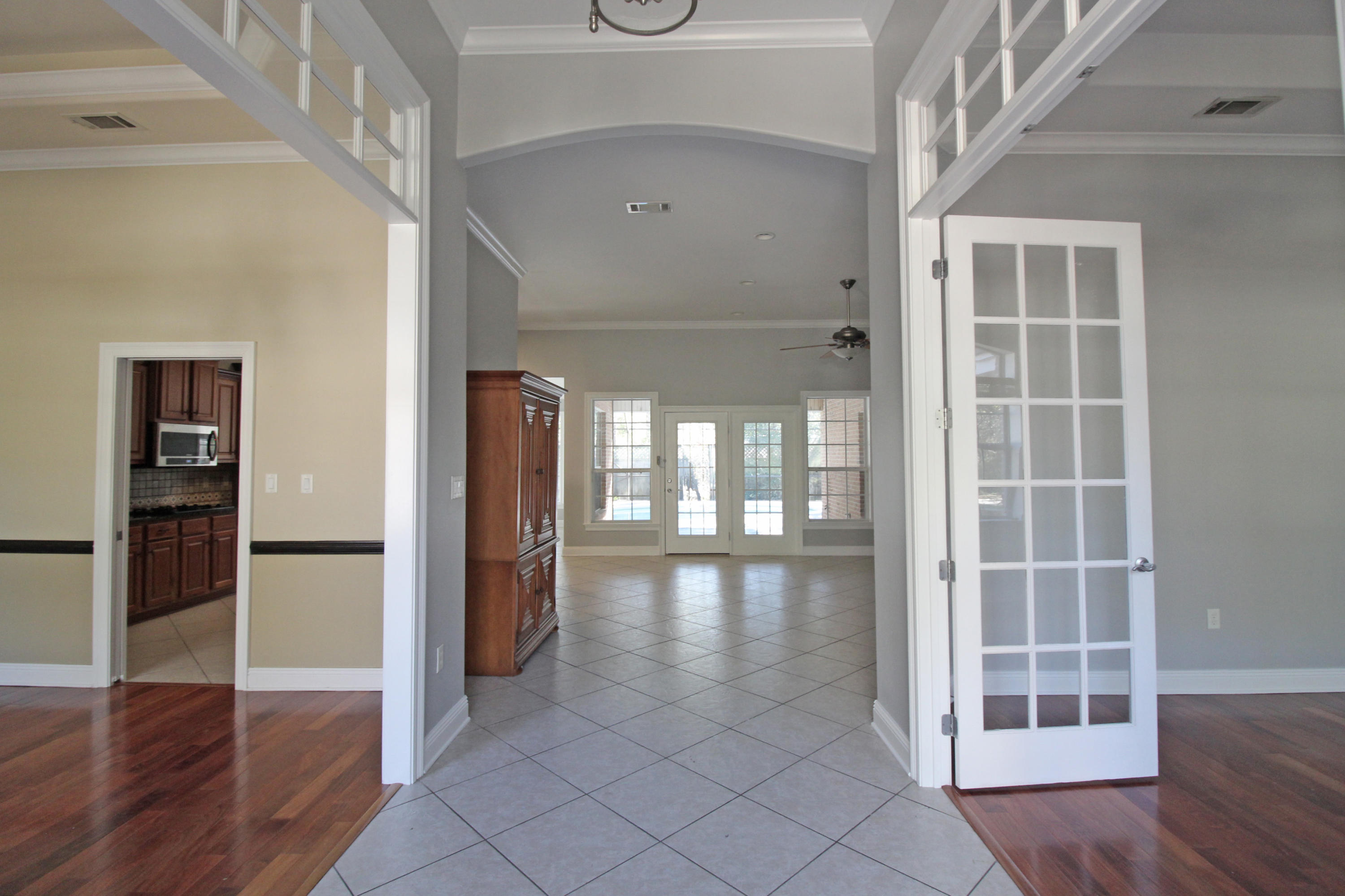 189 Red Maple Way Niceville, FL 32578 - Photo 8 of 58 a view of empty room with wooden floor and fan