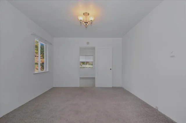 a view of an empty room and closet