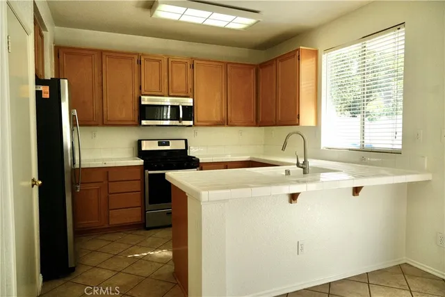 a kitchen with a stove a sink and a microwave