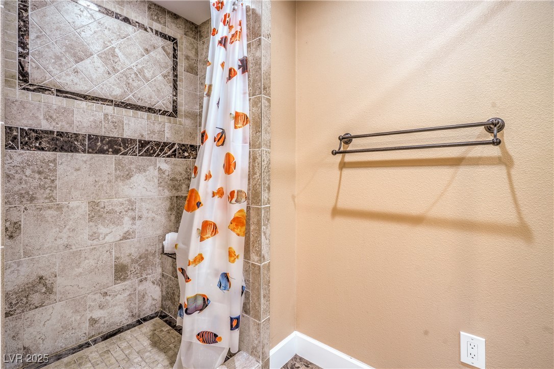 1201 I Boulder City, NV 89005 - Photo 21 of 26 Full bathroom featuring tiled shower and baseboards