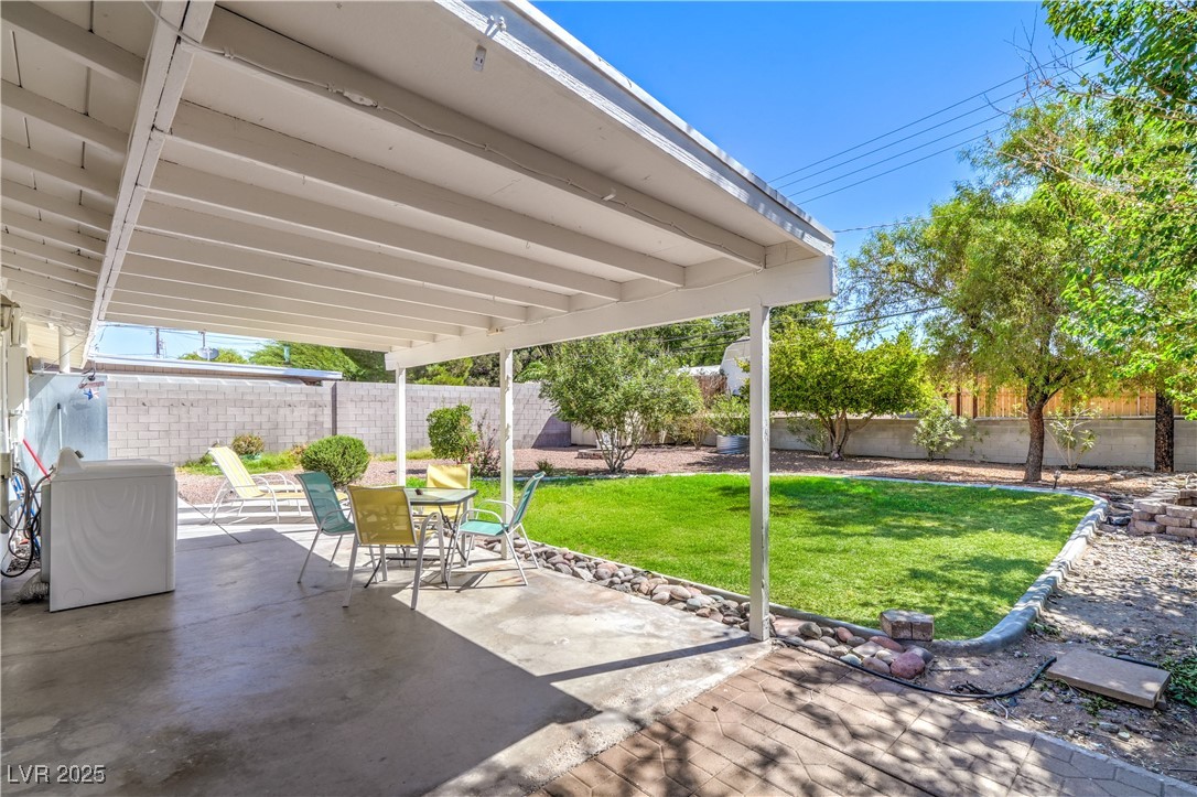1201 I Boulder City, NV 89005 - Photo 23 of 26 Fenced backyard featuring a patio and outdoor dining space