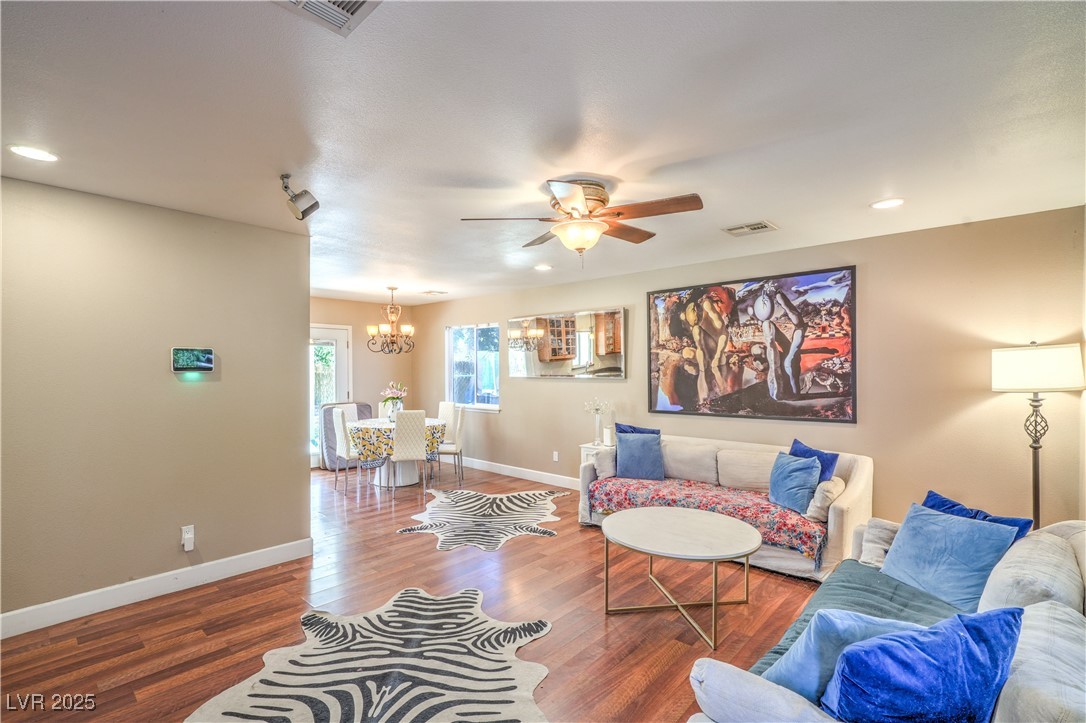 1201 I Boulder City, NV 89005 - Photo 7 of 26 Living room with a chandelier, a ceiling fan, wood finished floors, and recessed lighting