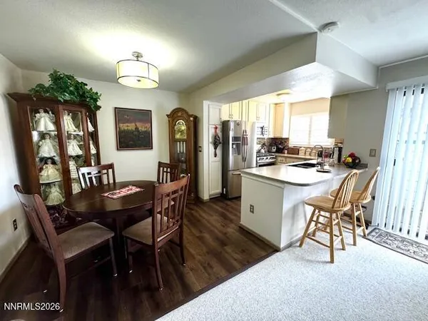 a kitchen with a table chairs stove and cabinets