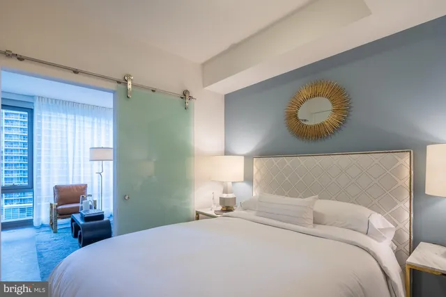 a bedroom with a bed and a chair