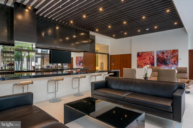 a living room with stainless steel appliances kitchen island granite countertop furniture and a kitchen view