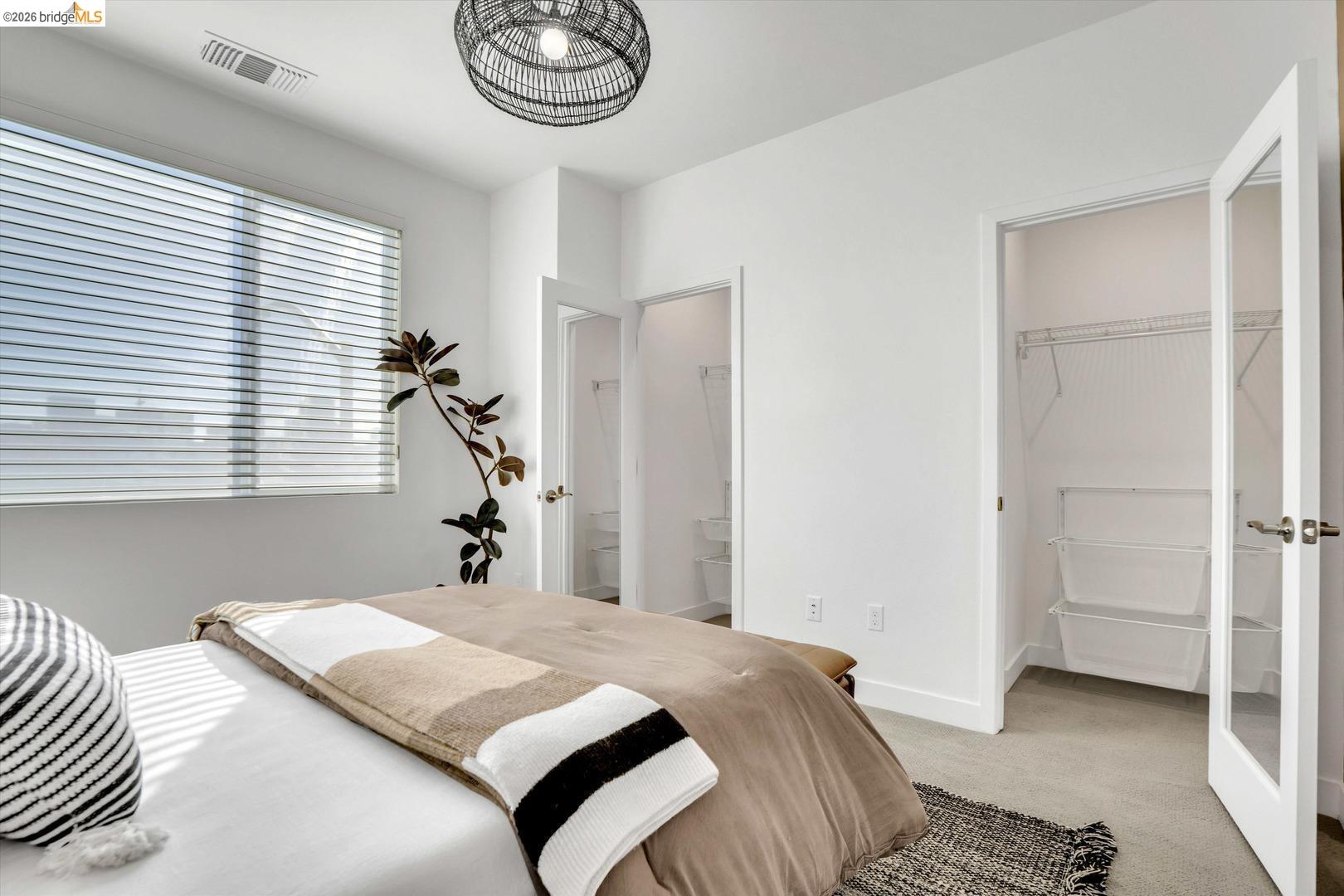 2229 Myrtle Street Oakland, CA 94607 - Photo 19 of 37 bedroom with light carpet, a spacious closet, and ensuite bathroom