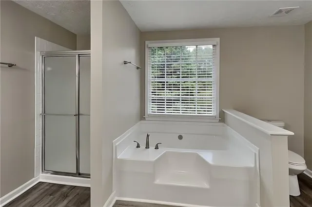 a bathroom with bathtub and a shower