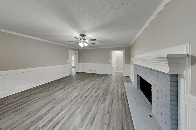 wooden floor in an empty room with a fireplace