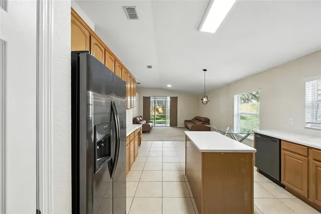 a kitchen with stainless steel appliances a refrigerator sink stove microwave and cabinets