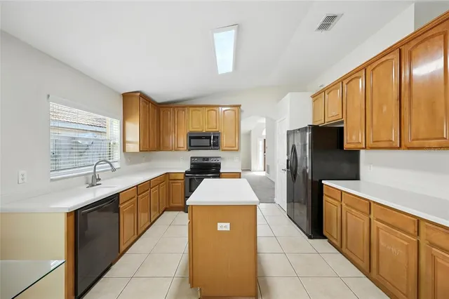 a kitchen with stainless steel appliances a stove sink and refrigerator