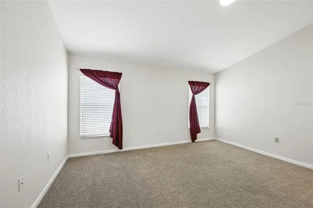 a bathroom with a double vanity sink a toilet a mirror and shower