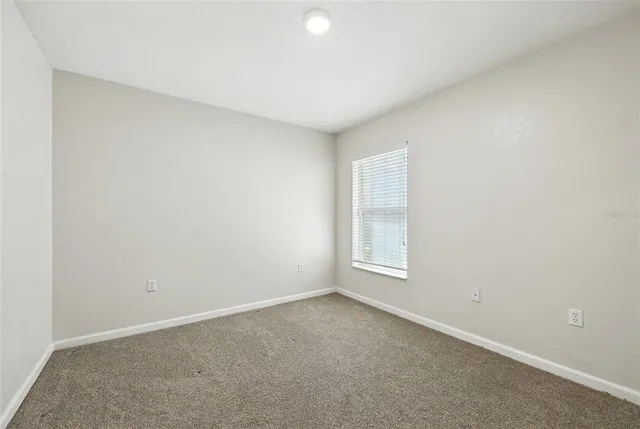 a bedroom with two beds and a painting on the wall