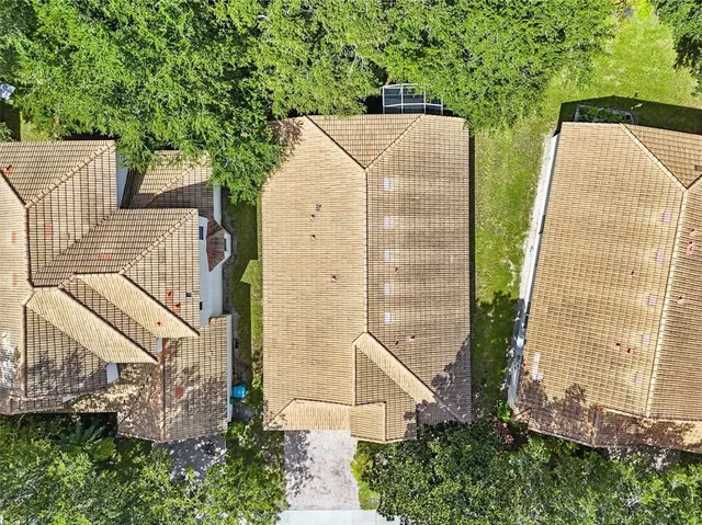 an aerial view of a house with balcony and trees