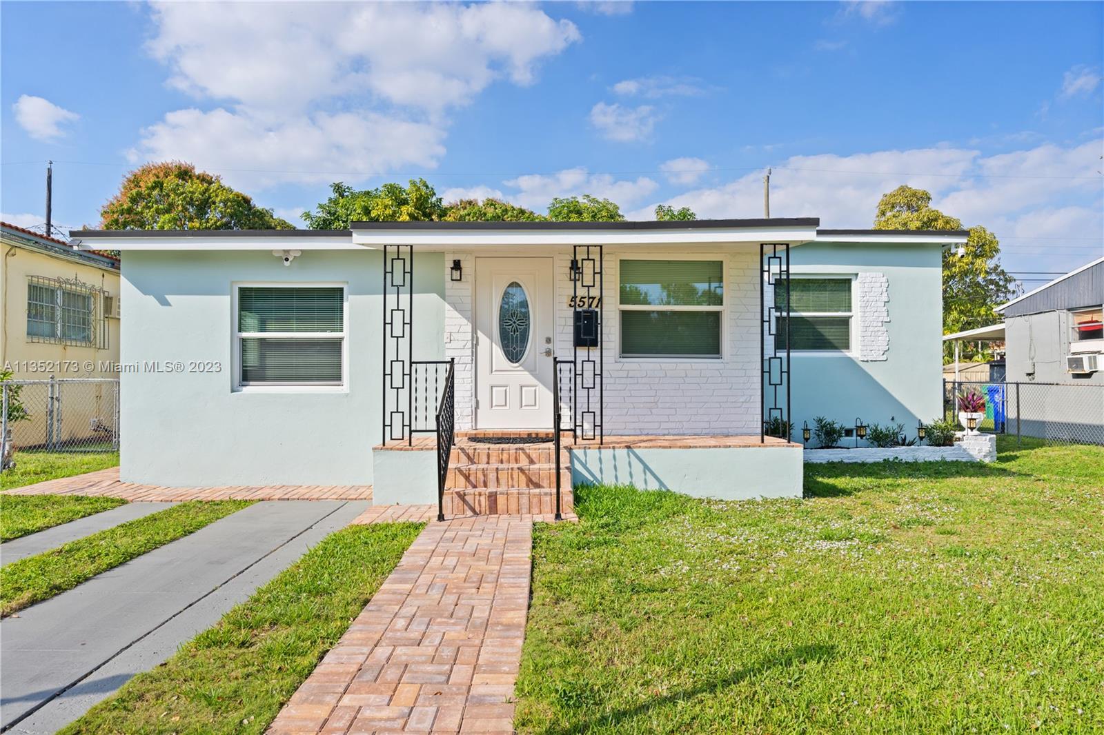 a front view of a house with a yard and porch