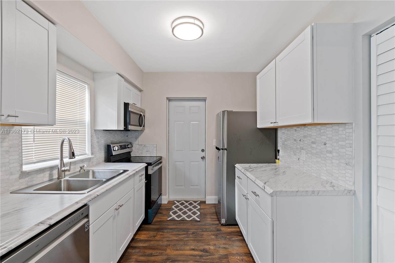 5571 Southwest 5th Terrace Miami, FL 33134 - Photo 13 of 37 a kitchen with white cabinets and sink
