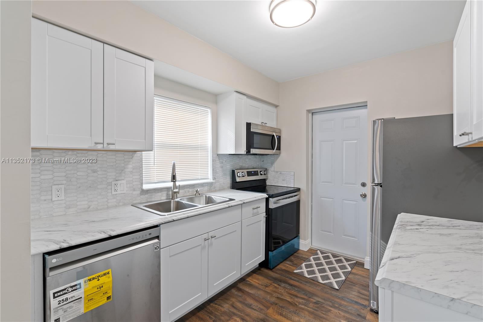 5571 Southwest 5th Terrace Miami, FL 33134 - Photo 14 of 37 a kitchen with a sink stove and refrigerator