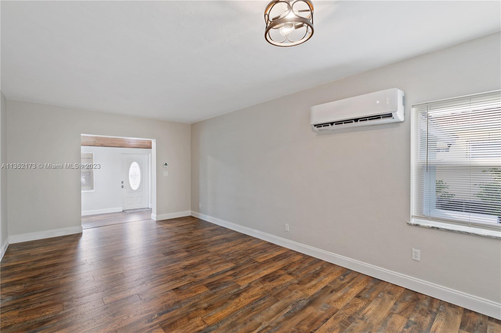 5571 Southwest 5th Terrace Miami, FL 33134 - Photo 16 of 37 an empty room with wooden floor and windows