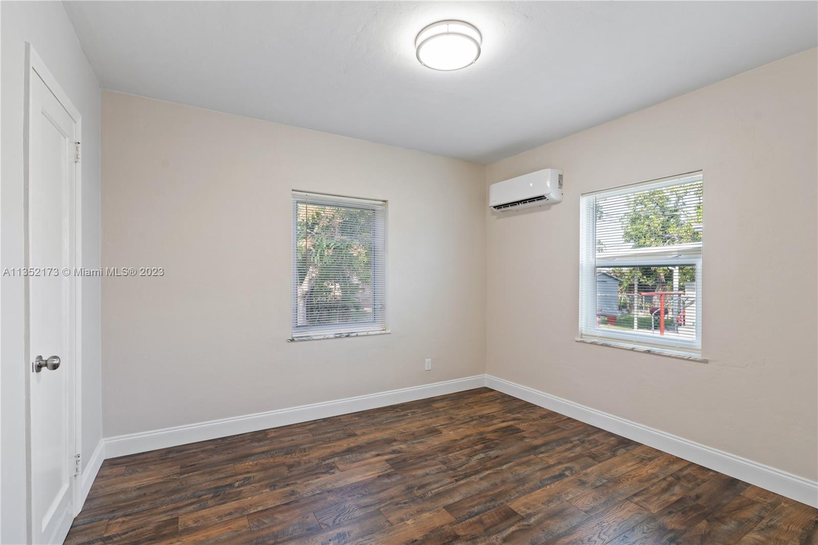 5571 Southwest 5th Terrace Miami, FL 33134 - Photo 20 of 37 a view of an empty room with wooden floor and a window