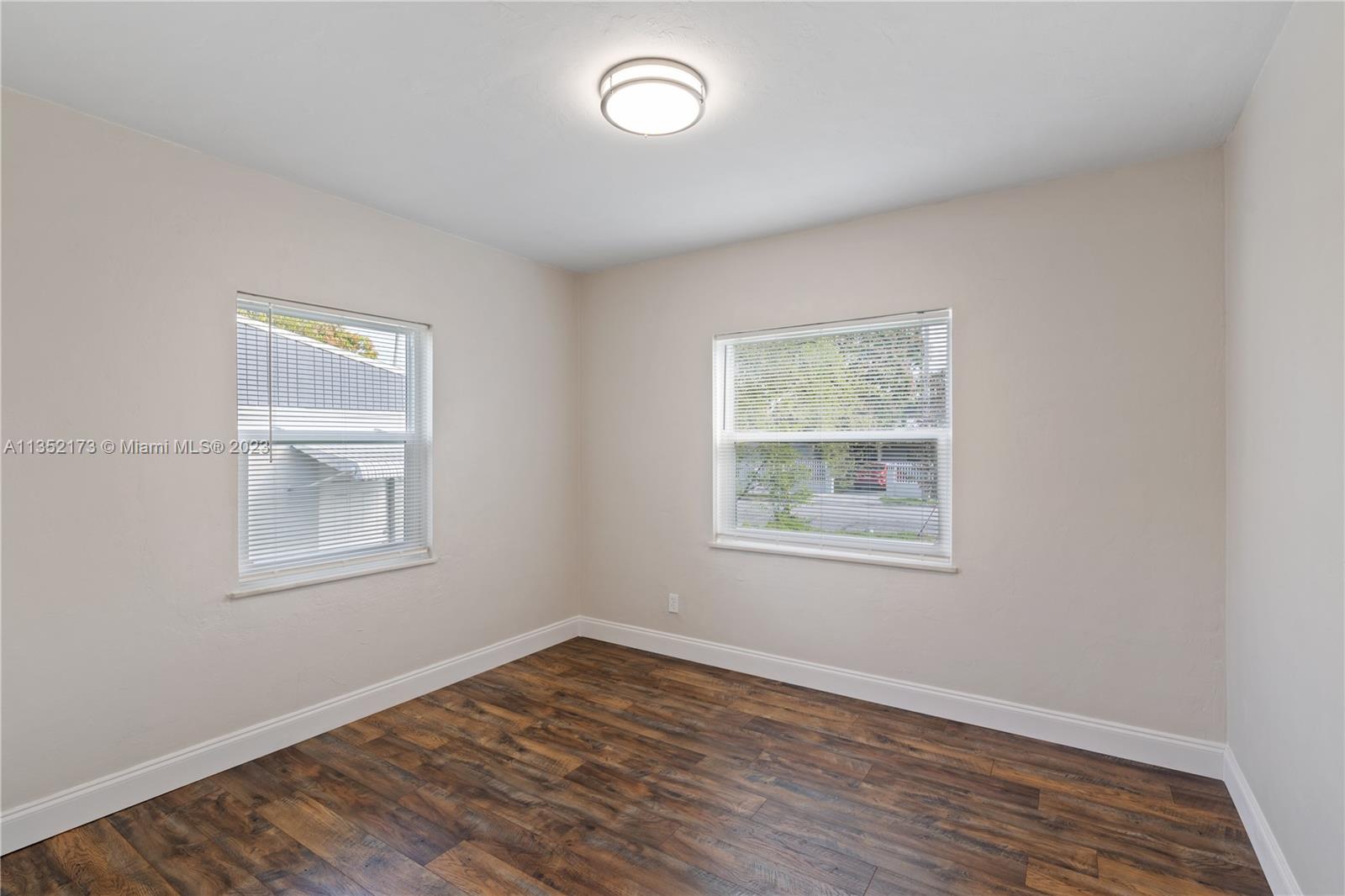 5571 Southwest 5th Terrace Miami, FL 33134 - Photo 21 of 37 a view of an empty room with wooden floor and a window