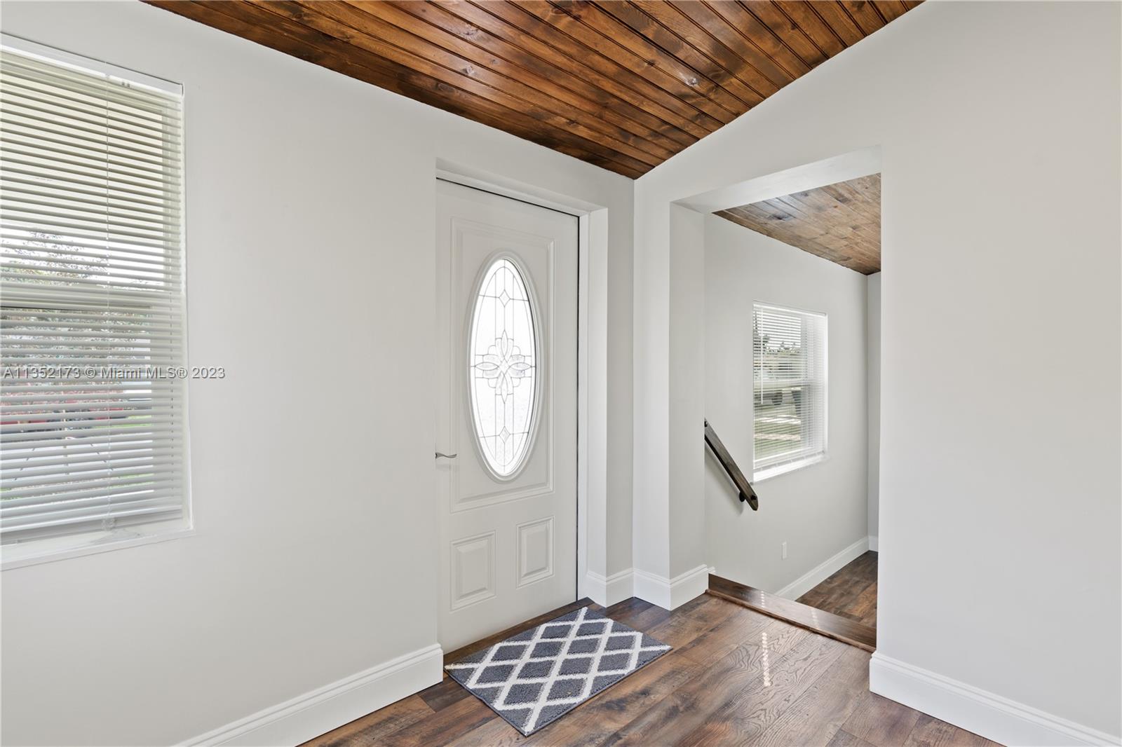 5571 Southwest 5th Terrace Miami, FL 33134 - Photo 6 of 37 a view of an empty room with wooden floor and a window