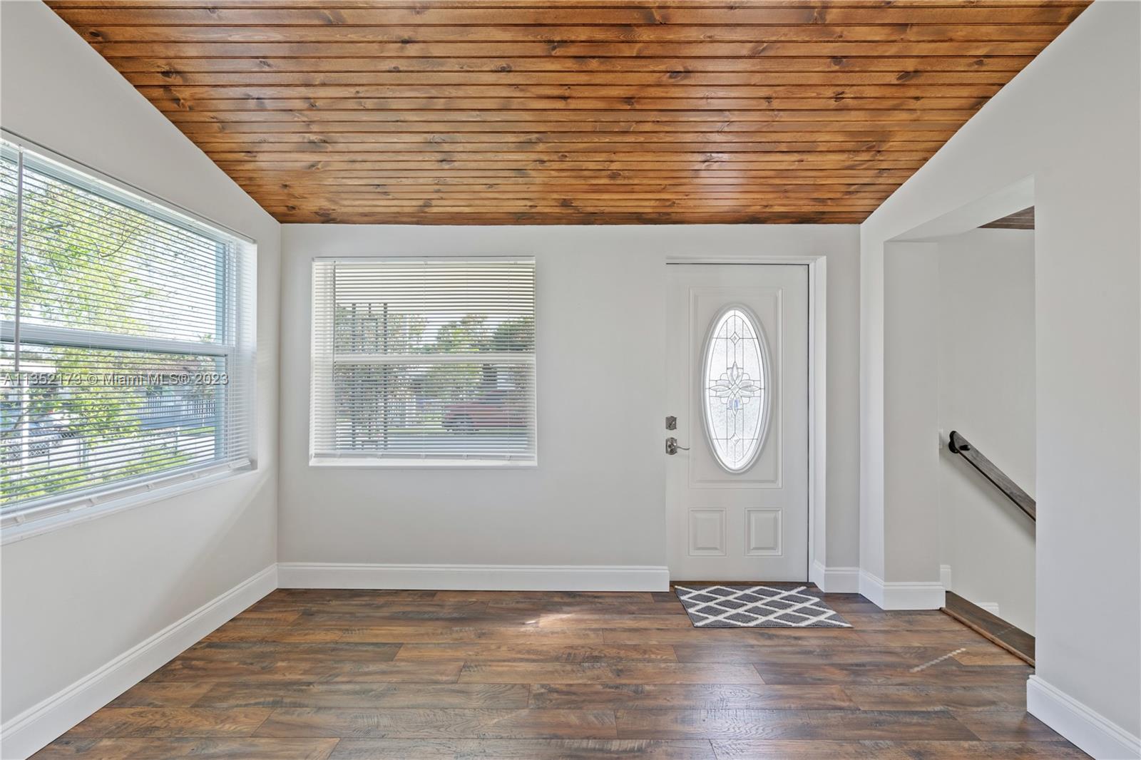 5571 Southwest 5th Terrace Miami, FL 33134 - Photo 7 of 37 a view of an empty room with wooden floor and a window
