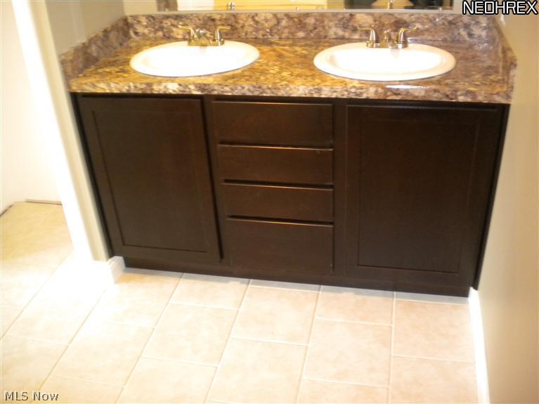 308 Barrington Ridge Road Painesville, OH 44077 - Photo 7 of 14 Master bath with ceramic tile and his and her sinks