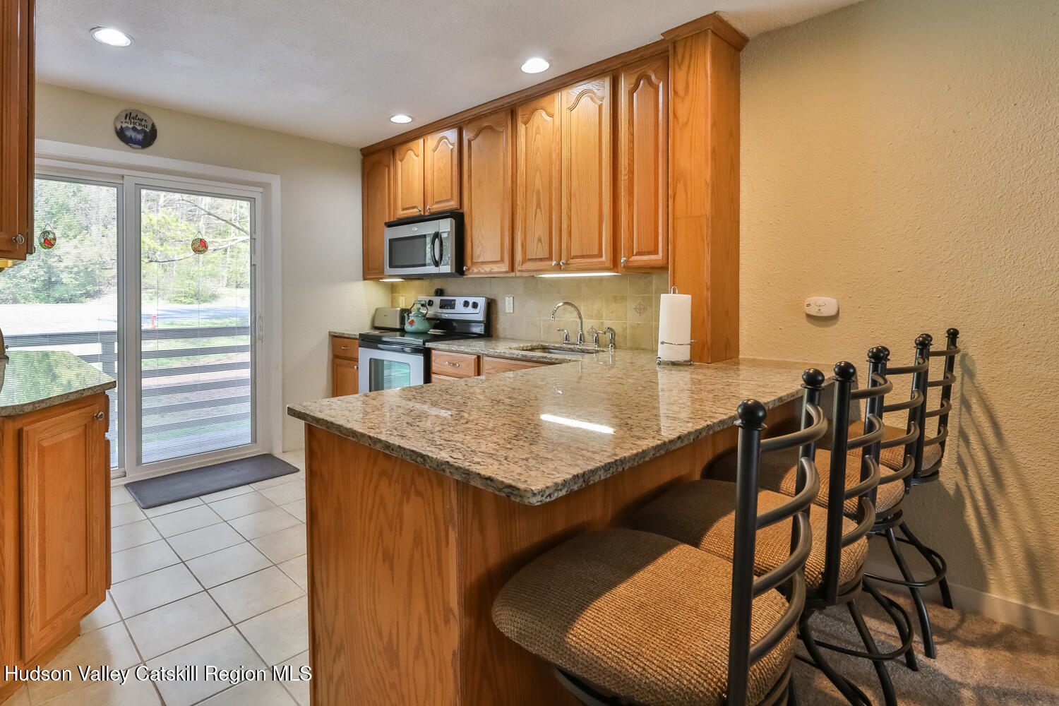 33 Scribner Hollow Road, Unit E4 Hunter, NY 12442 - Photo 11 of 44 a kitchen with a table chairs and a sink