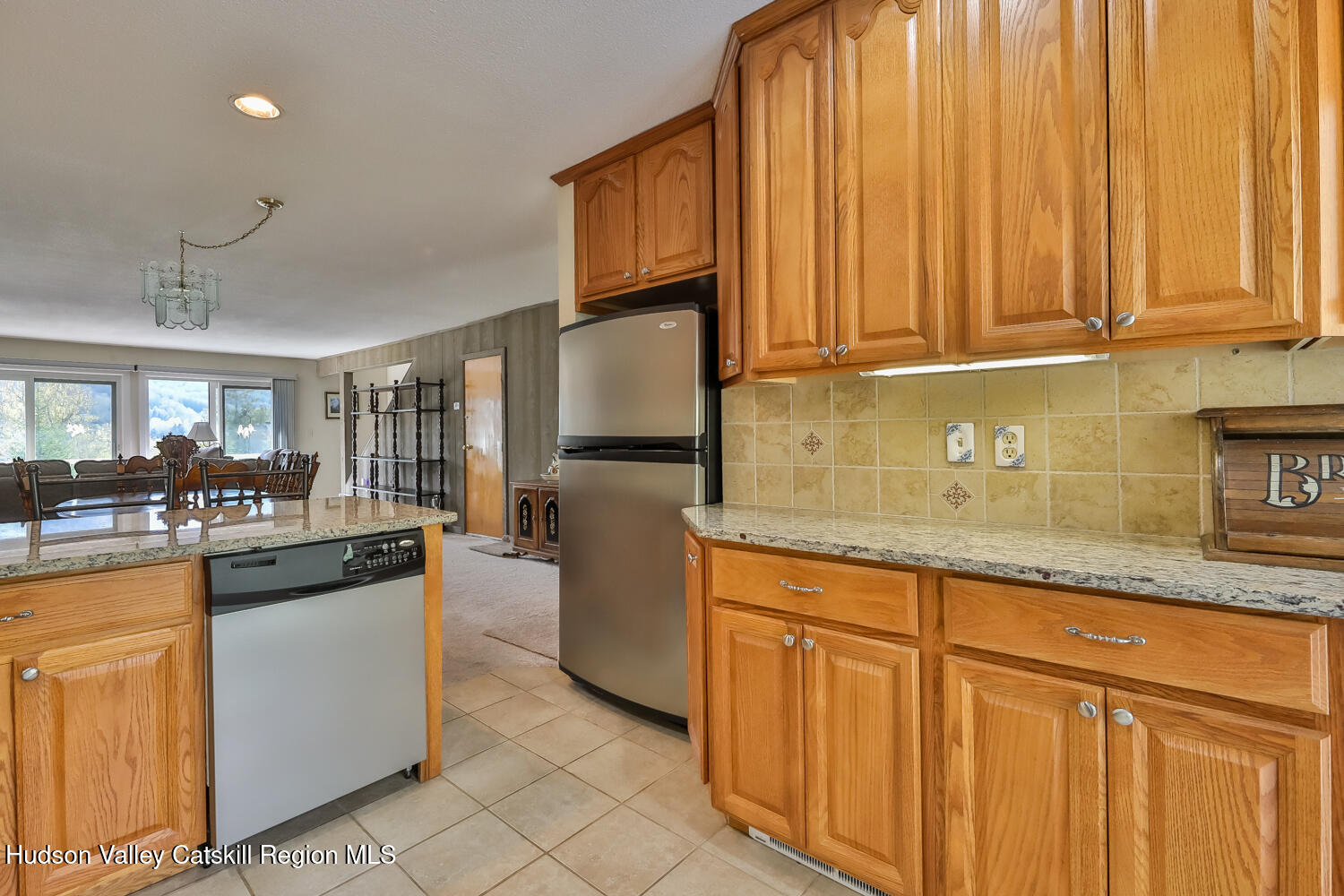 33 Scribner Hollow Road, Unit E4 Hunter, NY 12442 - Photo 13 of 44 a kitchen with granite countertop wooden cabinets and stainless steel appliances