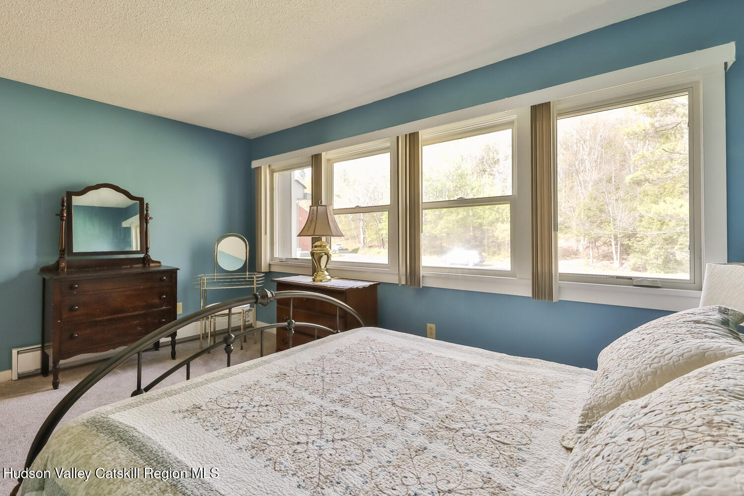 33 Scribner Hollow Road, Unit E4 Hunter, NY 12442 - Photo 26 of 44 a bedroom with a bed a table and windows