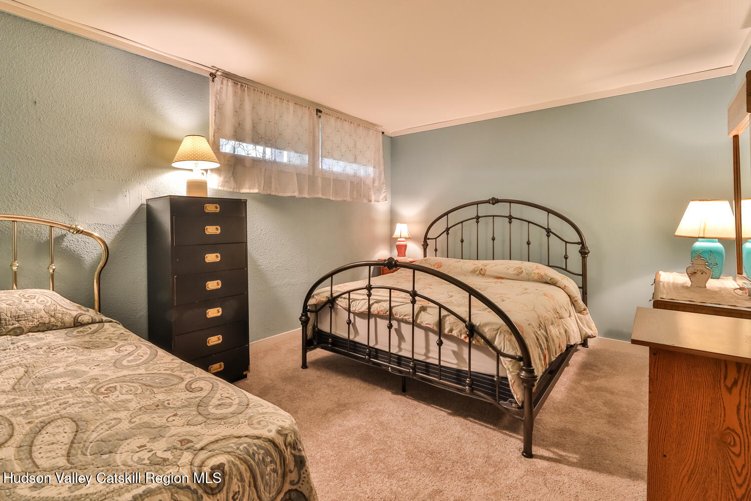 33 Scribner Hollow Road, Unit E4 Hunter, NY 12442 - Photo 36 of 44 a bedroom with a bed and a chandelier