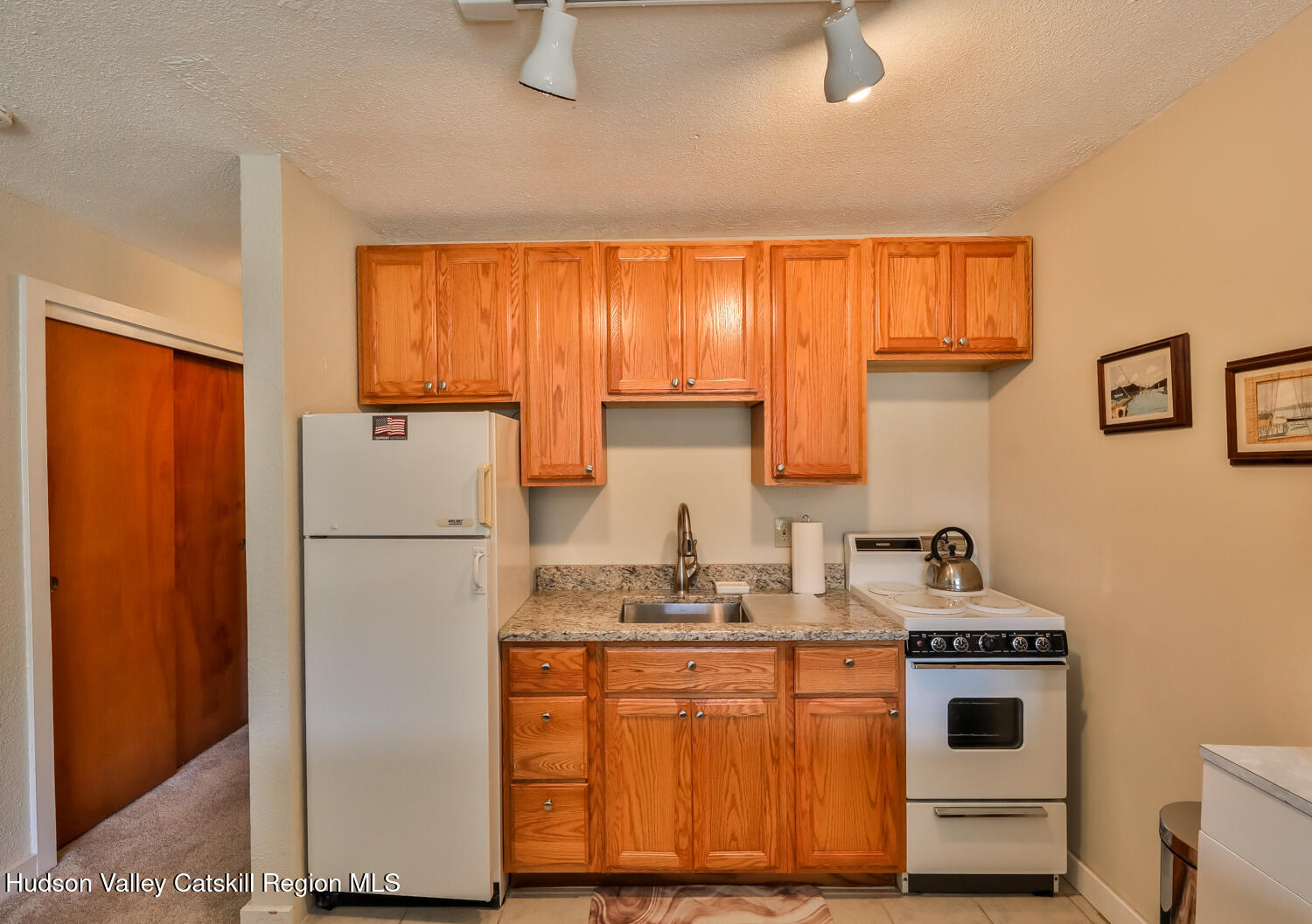 33 Scribner Hollow Road, Unit E4 Hunter, NY 12442 - Photo 38 of 44 a kitchen with a refrigerator sink stove and cabinets