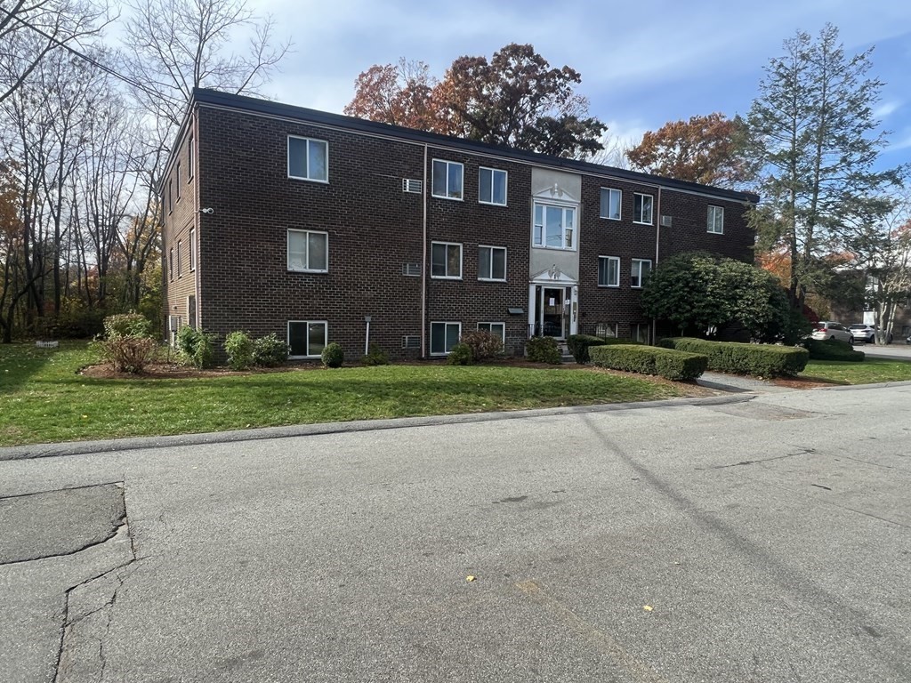 a view of a brick building next to a yard
