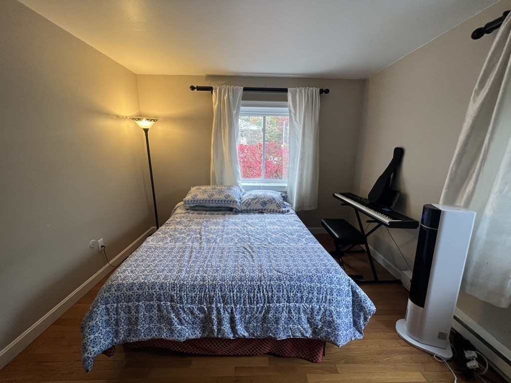 1 Universal Street, Unit 7 Framingham, MA 01702 - Photo 12 of 23 a bedroom with a bed and wooden floor