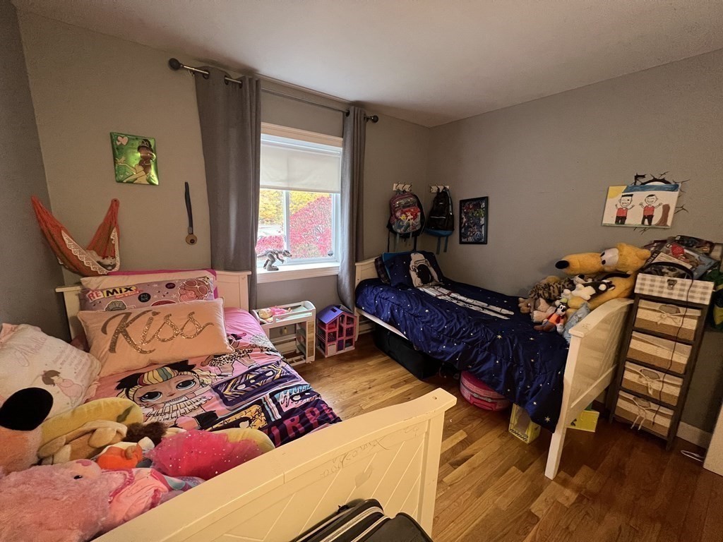 1 Universal Street, Unit 7 Framingham, MA 01702 - Photo 13 of 23 a bedroom with a bed and wooden floor