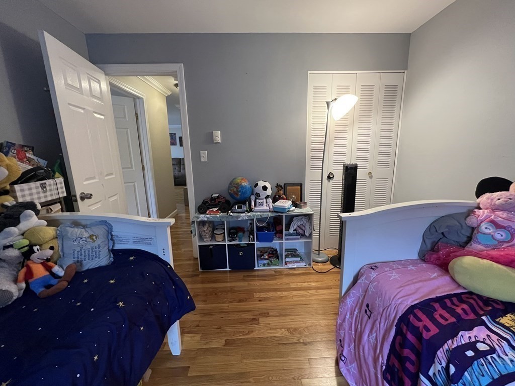 1 Universal Street, Unit 7 Framingham, MA 01702 - Photo 16 of 23 a bed room with furniture and a mirror