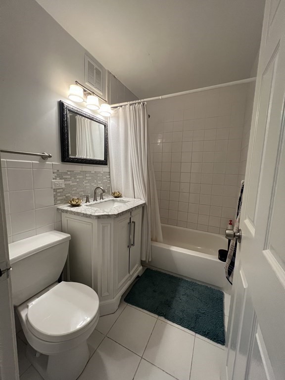 1 Universal Street, Unit 7 Framingham, MA 01702 - Photo 18 of 23 a bathroom with a granite countertop sink toilet and shower