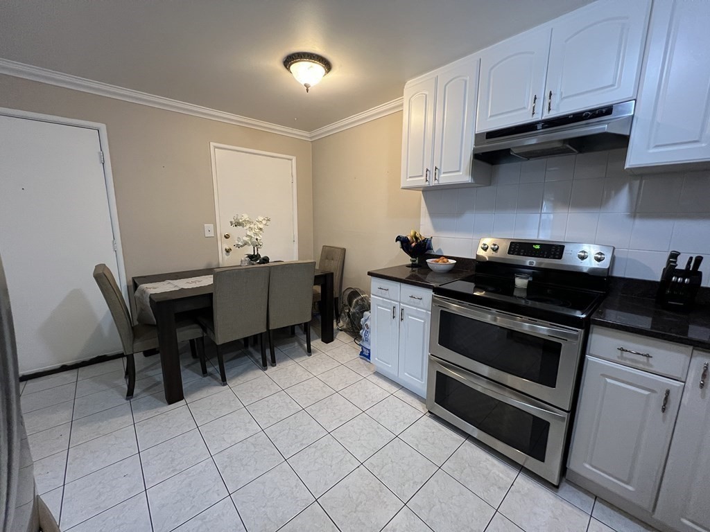 1 Universal Street, Unit 7 Framingham, MA 01702 - Photo 5 of 23 a kitchen with a stove and a cabinets