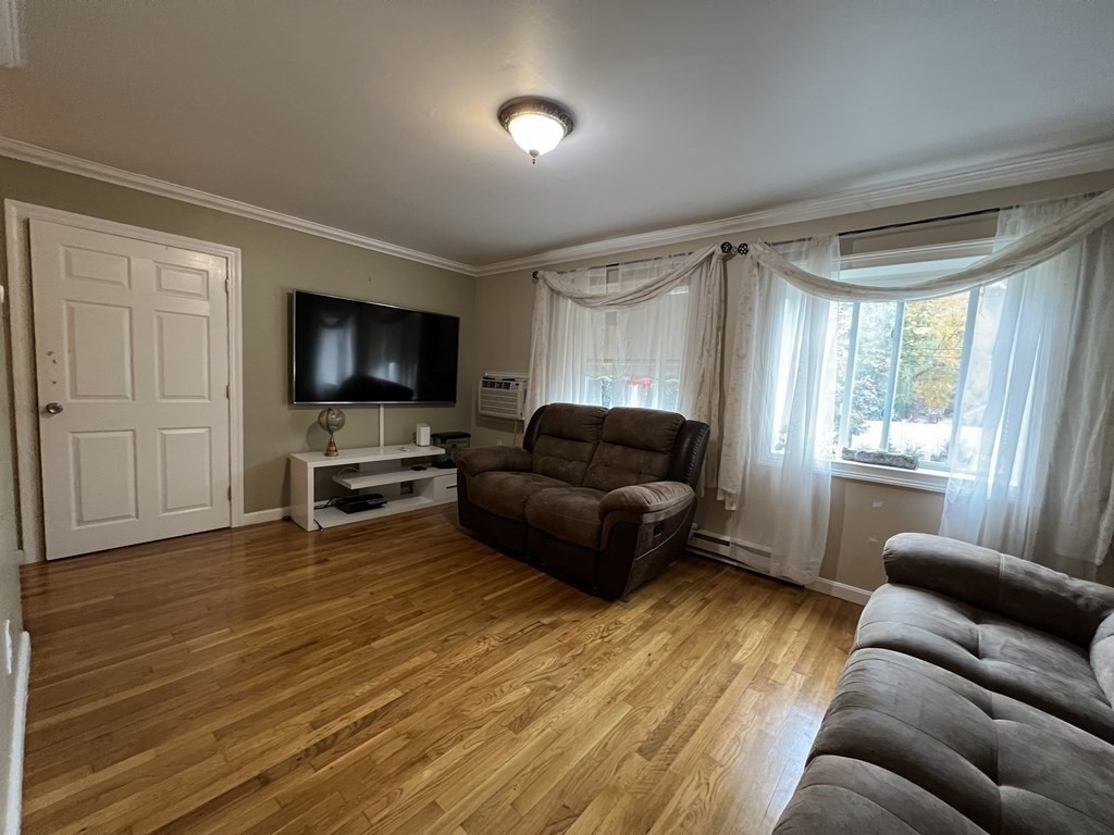 1 Universal Street, Unit 7 Framingham, MA 01702 - Photo 8 of 23 a living room with furniture and a flat screen tv