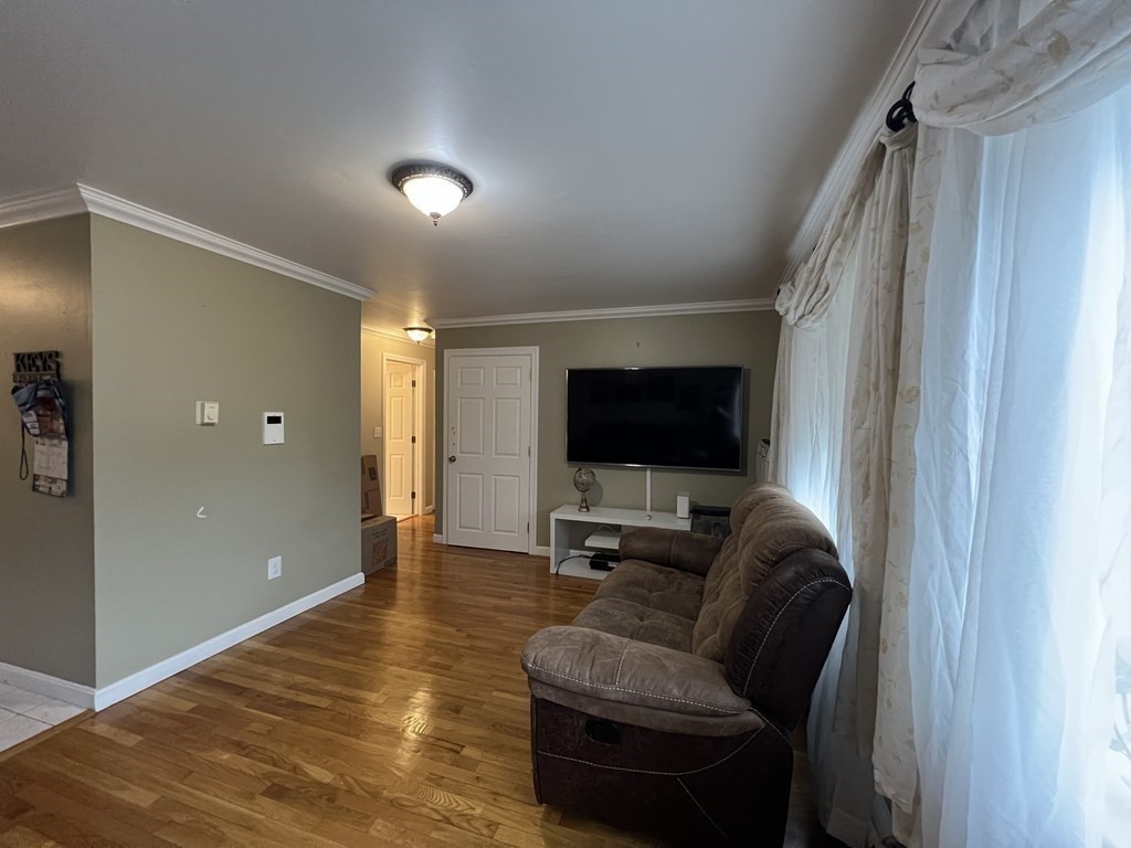 1 Universal Street, Unit 7 Framingham, MA 01702 - Photo 9 of 23 a living room with furniture and a flat screen tv