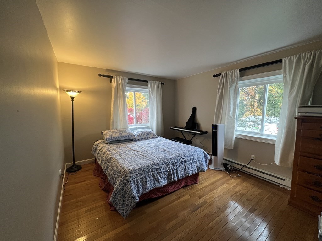 1 Universal Street, Unit 7 Framingham, MA 01702 - Photo 10 of 23 a bedroom with a bed and a window