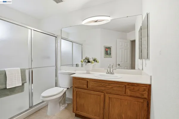 a bathroom with a sink vanity mirror and toilet