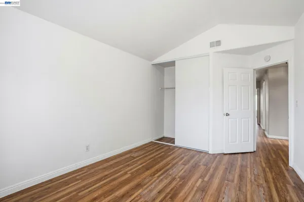 a view of a room with wooden floor and white doors