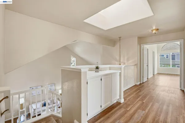 a view of a hallway with wooden floor and entryway
